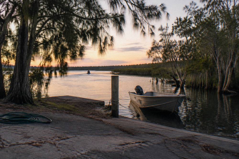 Quiet river landing with a small boat moored among trees